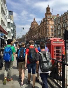 Back of group of students on walking tour around London on excursion at Sir Laurence residential English summer camp